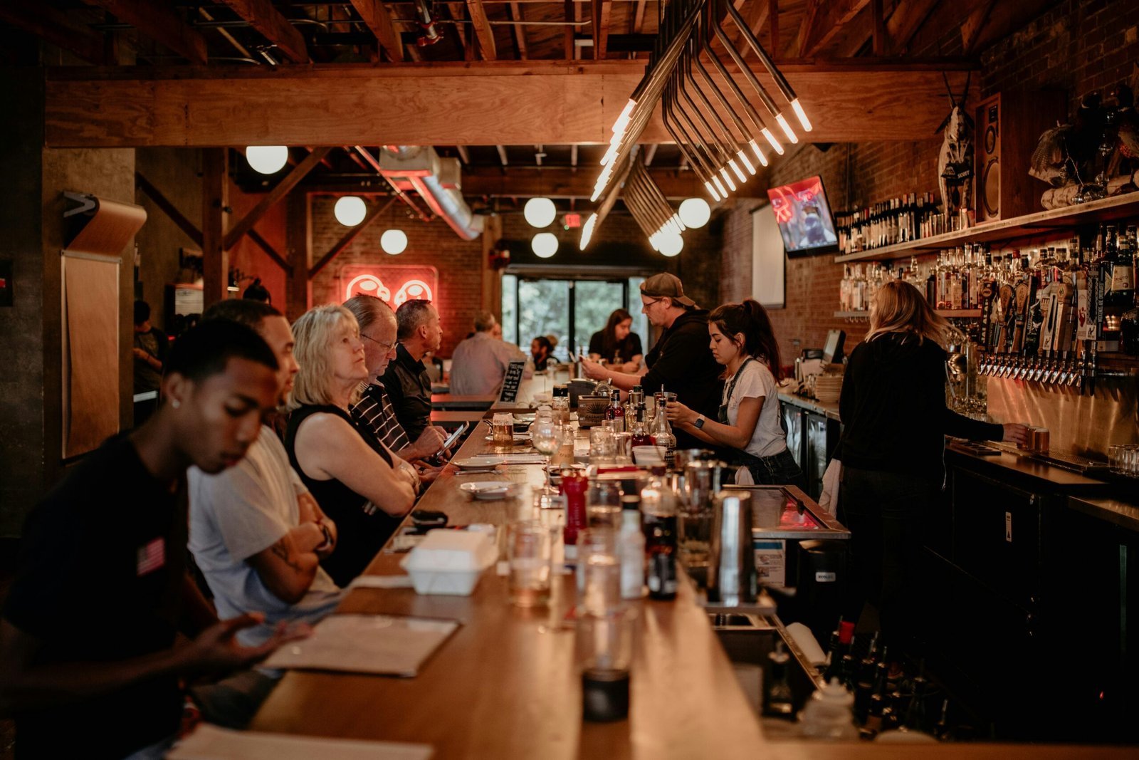 a group of people sitting at a bar