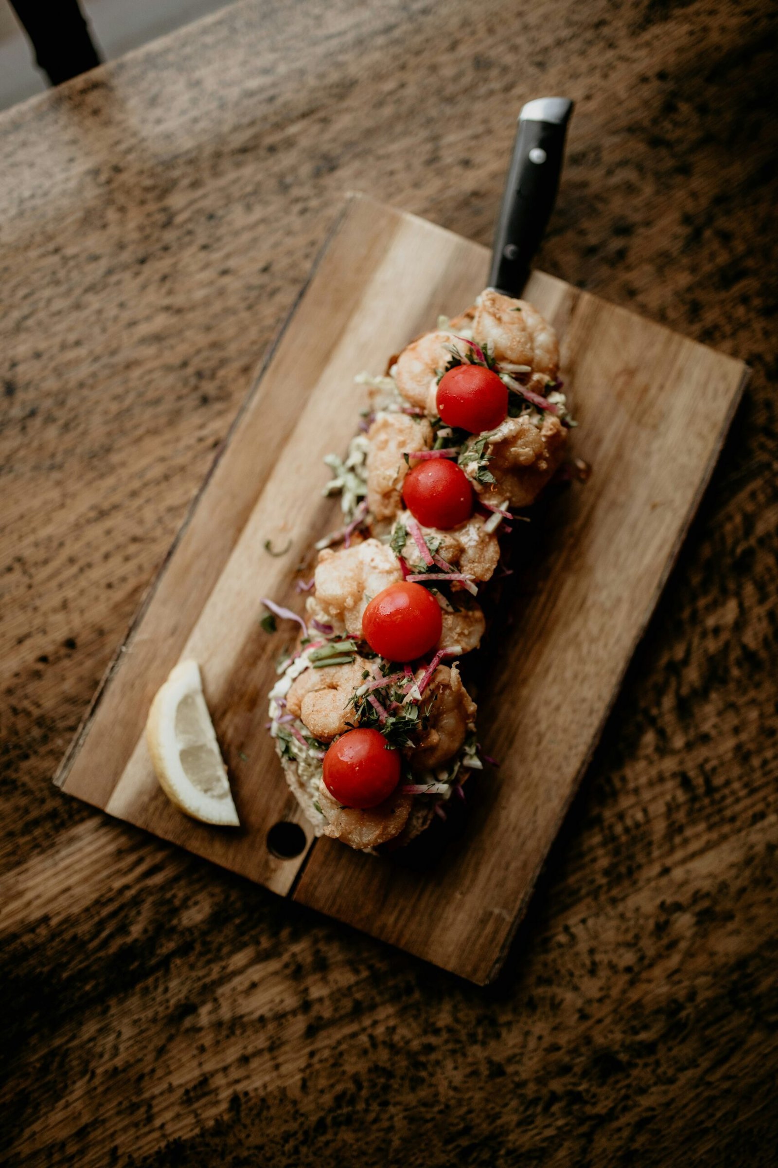 a wooden cutting board topped with meat and veggies